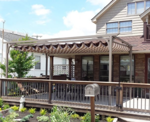 A rich brown Sunesta retractable canopy, providing shade over a Lehigh Valley porch.